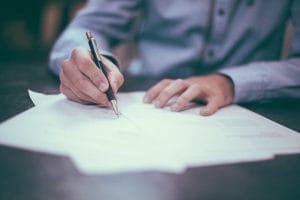 Man filling out documents