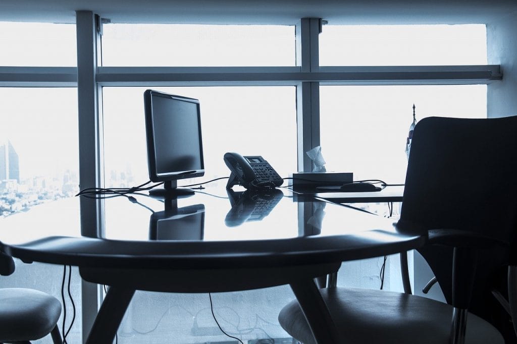 Desk with a phone and monitor