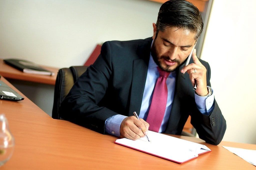 Business man having a phone call and taking notes