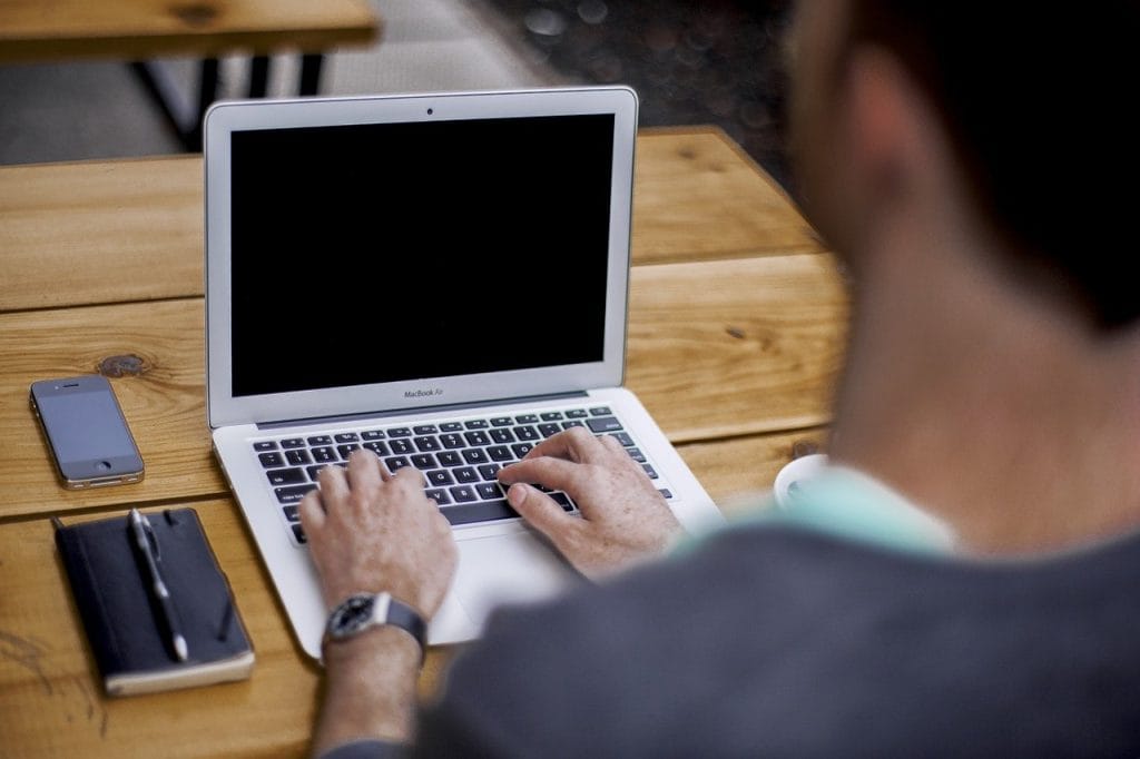 Man typing on his laptop
